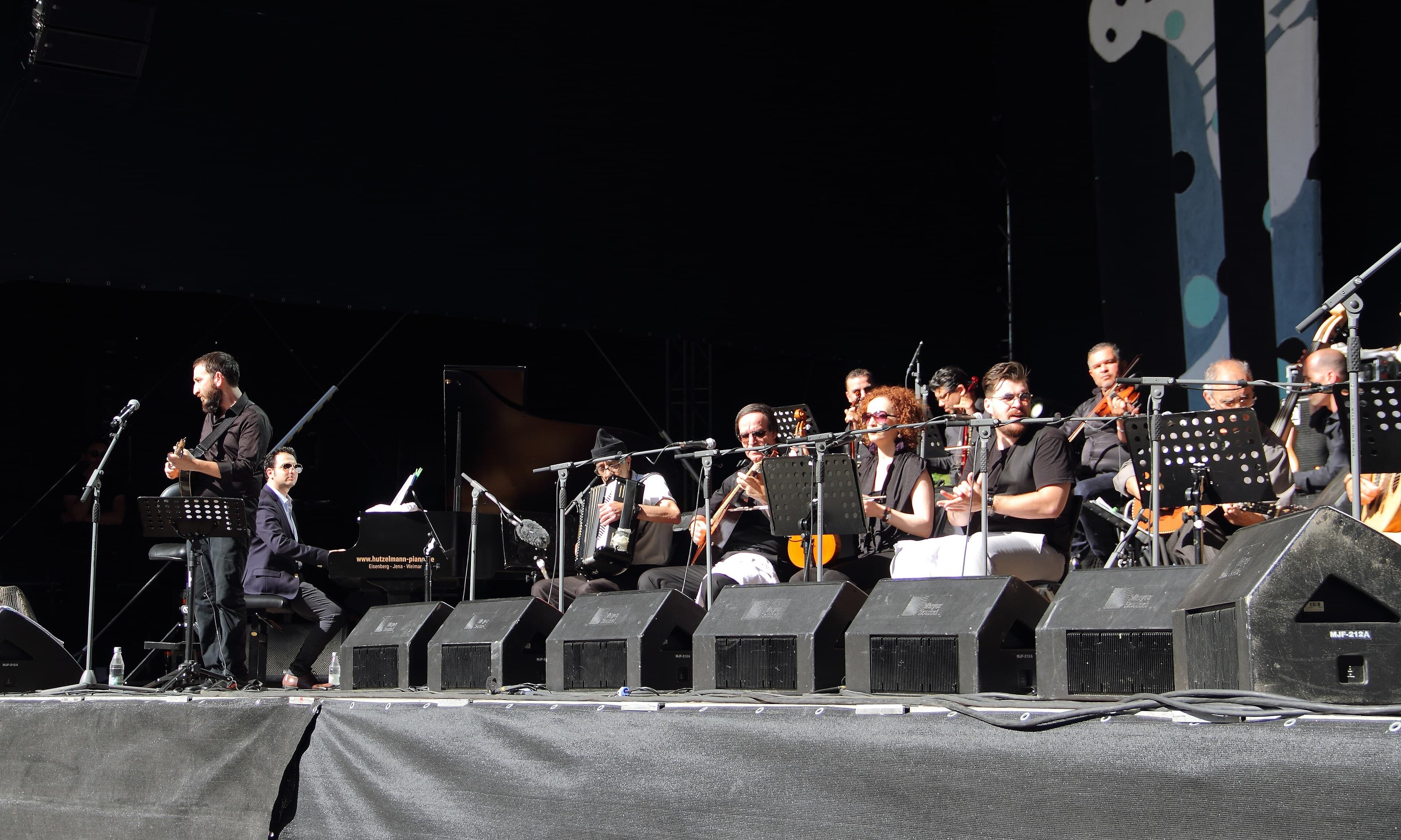 Chaabi musicians playing mandole, lute and small drums together in a café performance