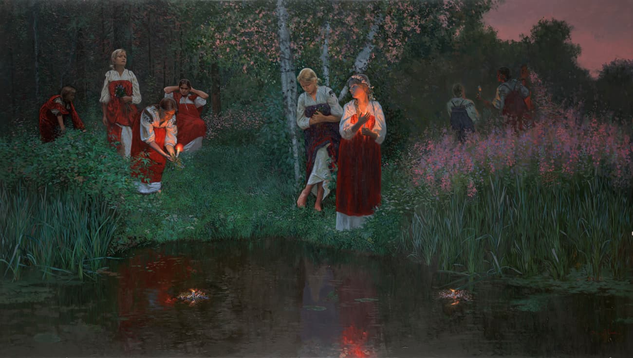 Girls wearing flower wreaths floating on a river at sunset