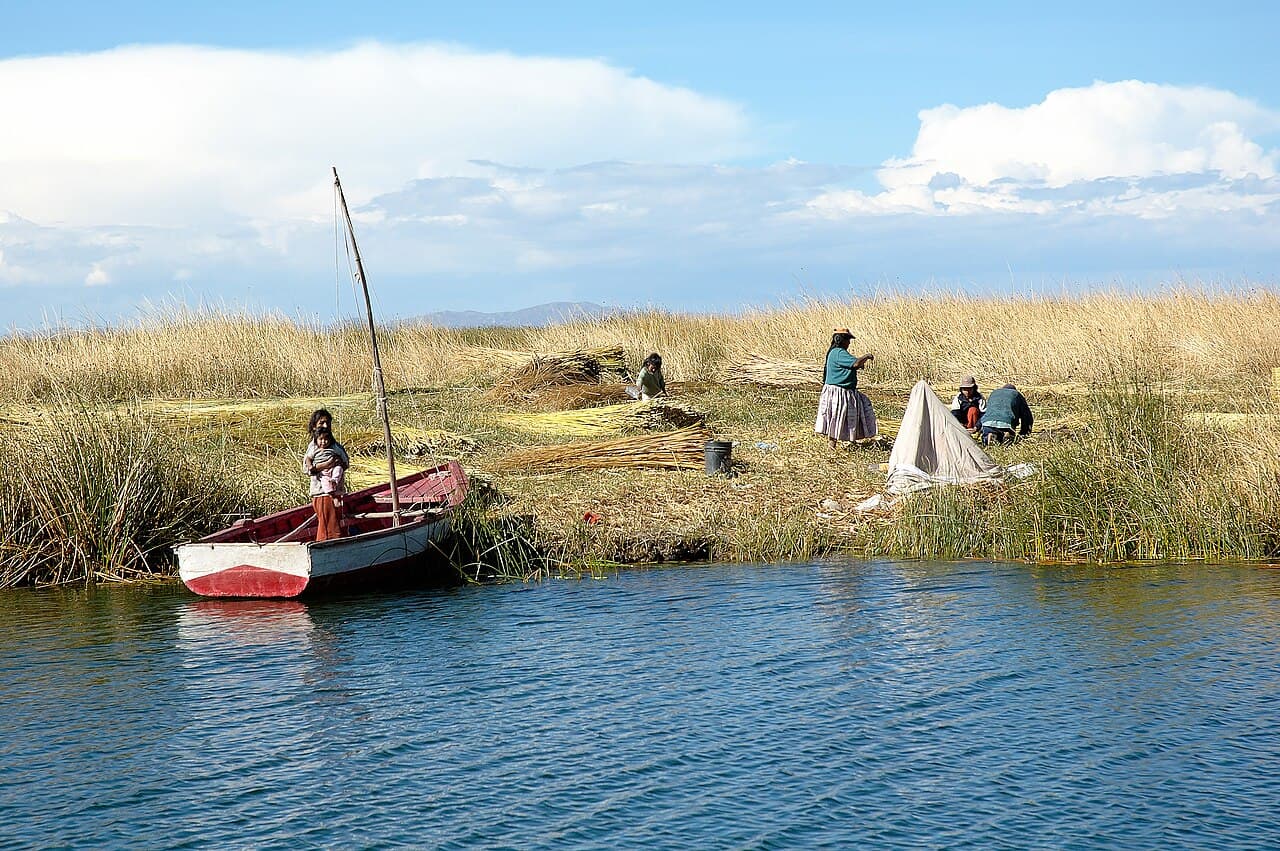 A small reed boat at the edge of a floating reed island on Lake Titicaca