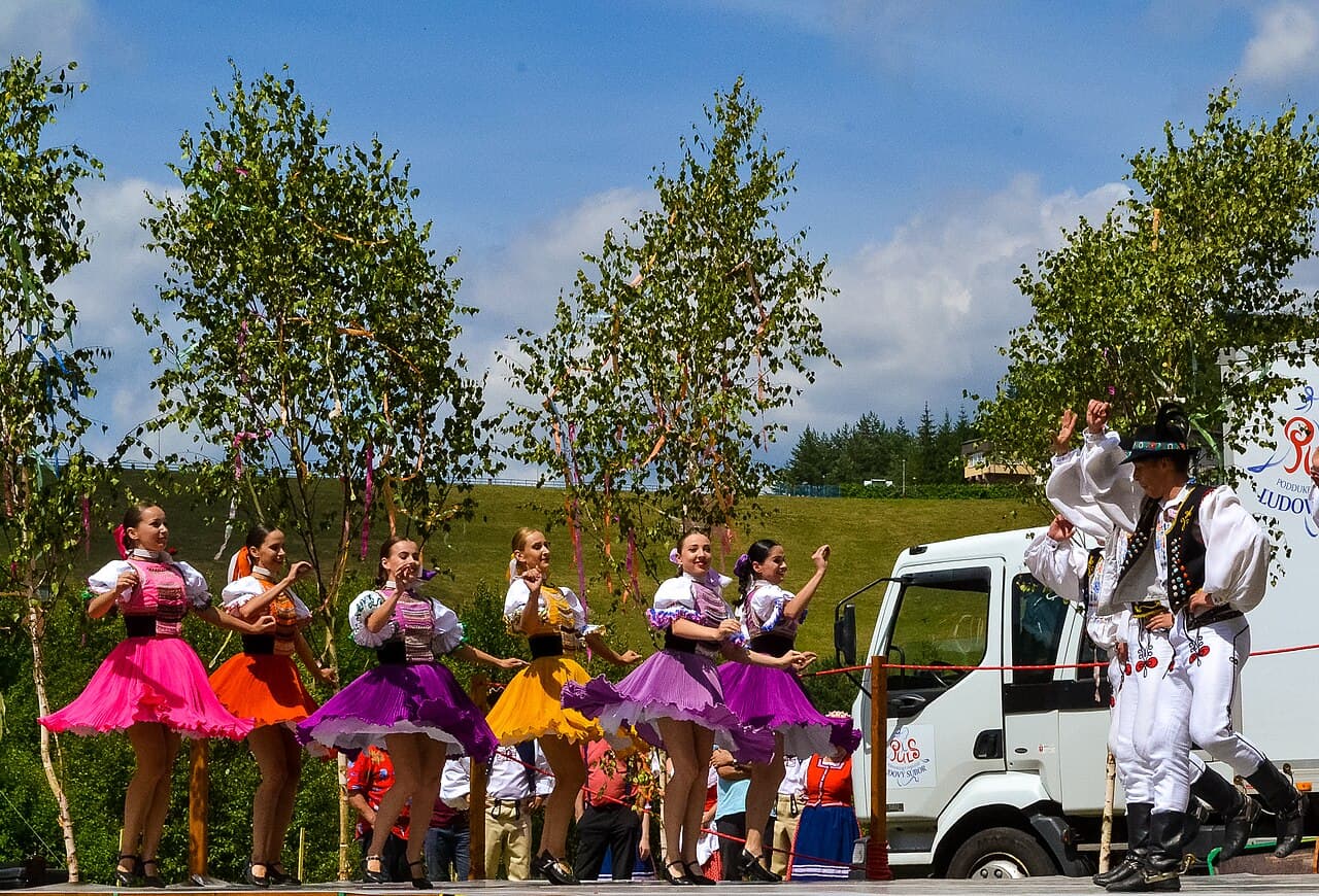 Slovak folk musicians playing fiddle and double bass in colourful traditional clothes